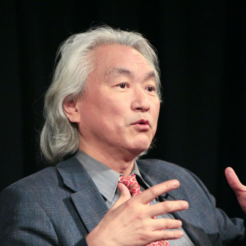 Physicist Michio Kaku speaks on stage and gestures with his hands