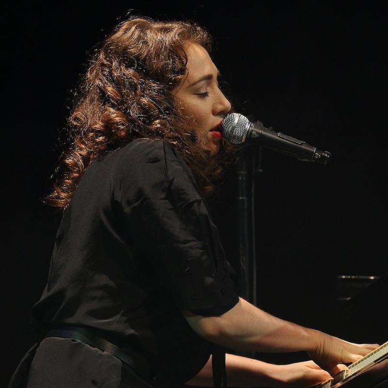 Musician Regina Spektor plays the piano on stage